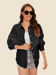 Black denim trucker jacket with fringe and pearl embellishments on sleeves and collar
