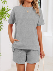 Gray relaxed two-piece set with crew neck t-shirt and shorts, featuring pockets.