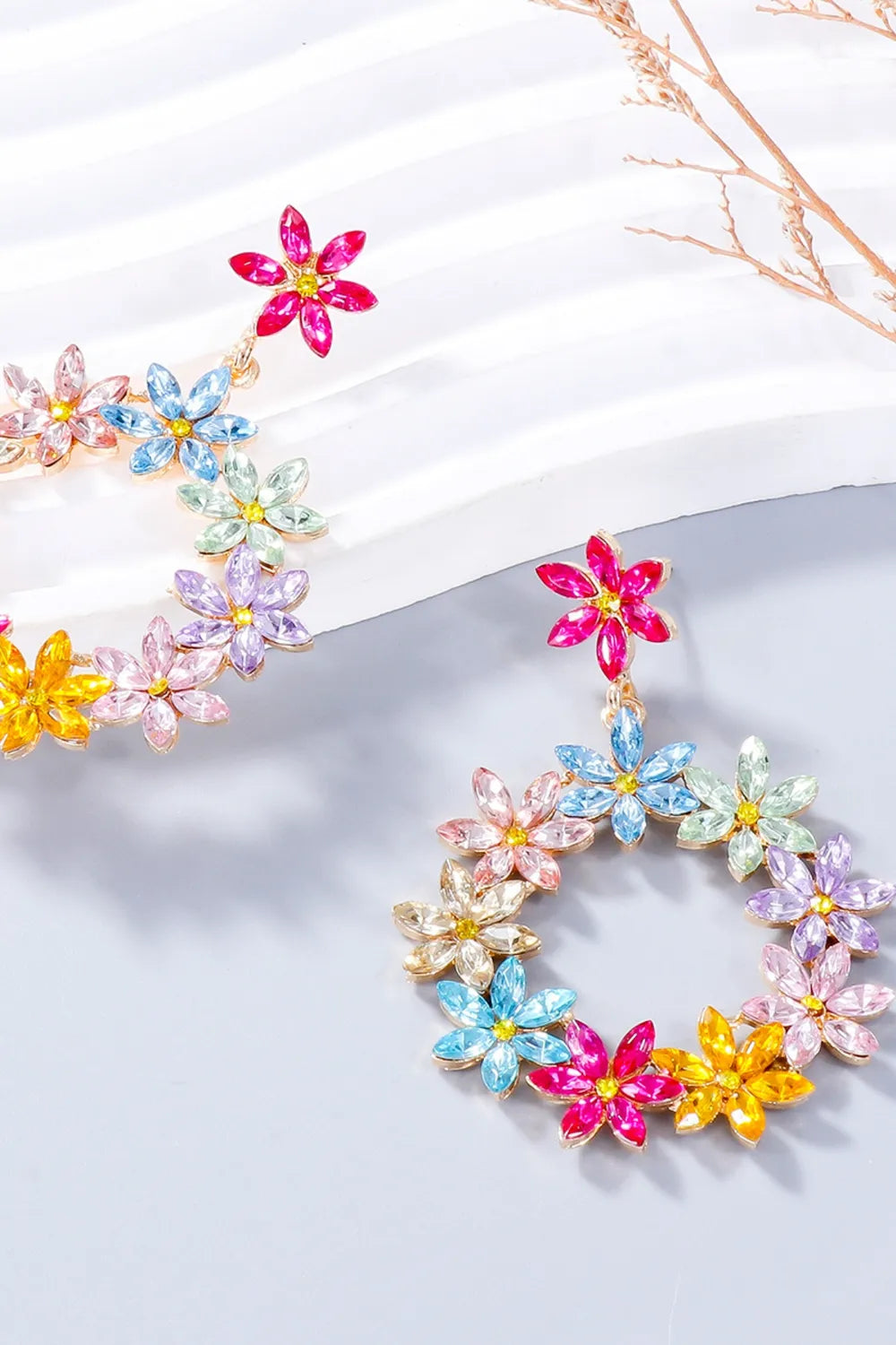 Floral halo drop earrings with multicolor crystal flowers and gold alloy.