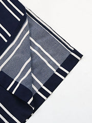 Dark blue and white striped palazzo trousers with a slit leg detail.