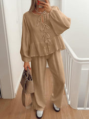 Camel textured peplum co-ord set with tie-neck and balloon sleeves.