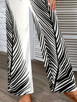 Palm print palazzo trousers in black and white, featuring a wide leg and split hem.