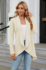 Drape-front cable knit cardigan in Tan with a waterfall neckline and asymmetrical hem.