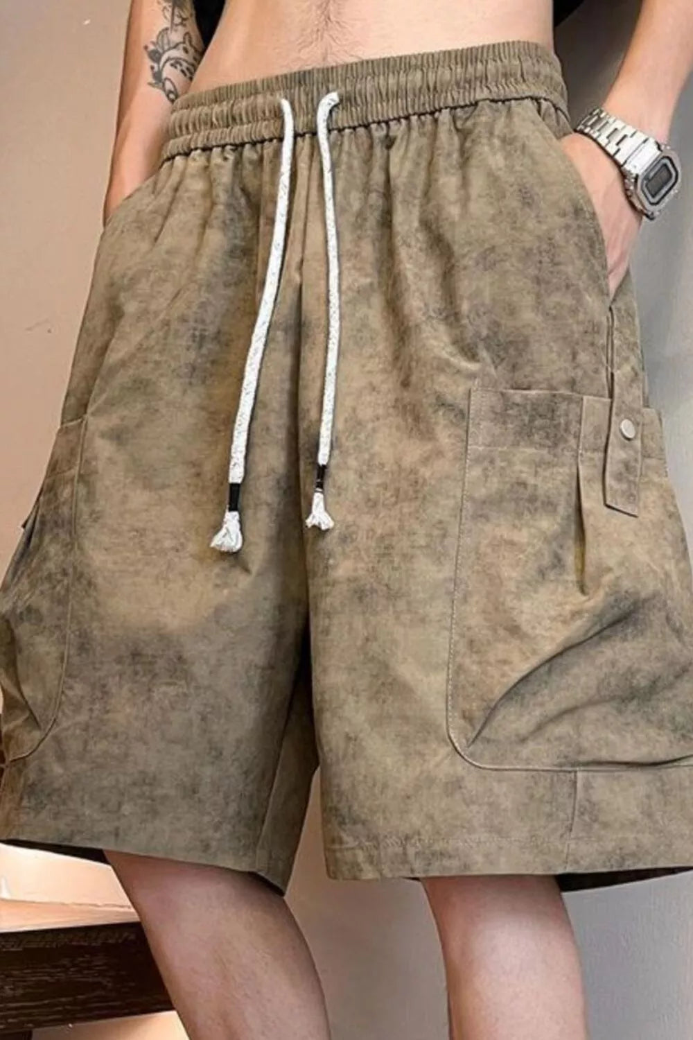 Relaxed fit cargo shorts in khaki with drawstring waist and multiple pockets.