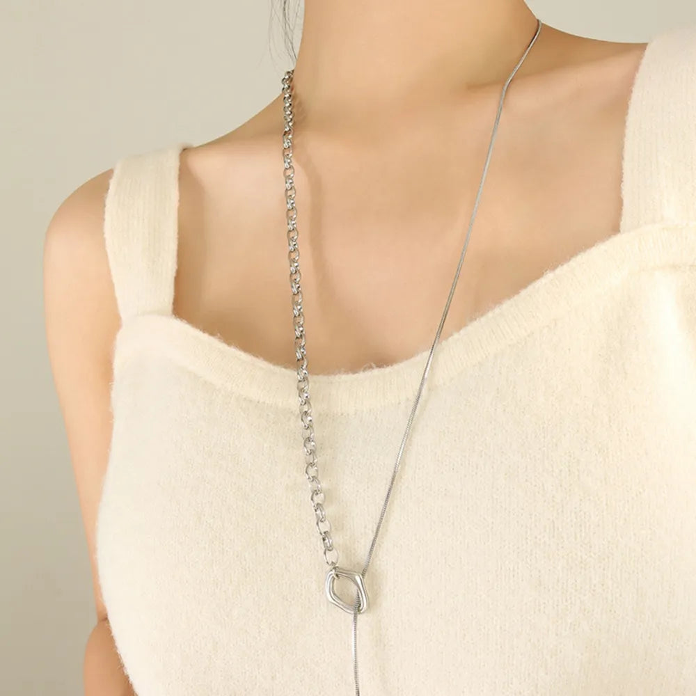 Silver asymmetrical chain and bar necklace with a snake chain detail.