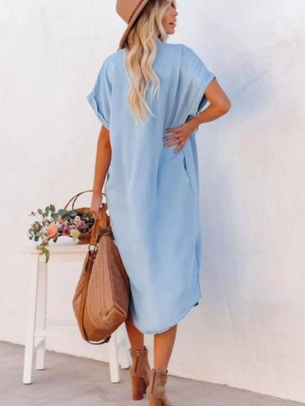 Light blue midi shirt dress with cuffed short sleeves and side slits, worn with a tan hat and boots.