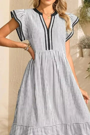 Striped midi dress with ruffle sleeves and V-neck with black trim.