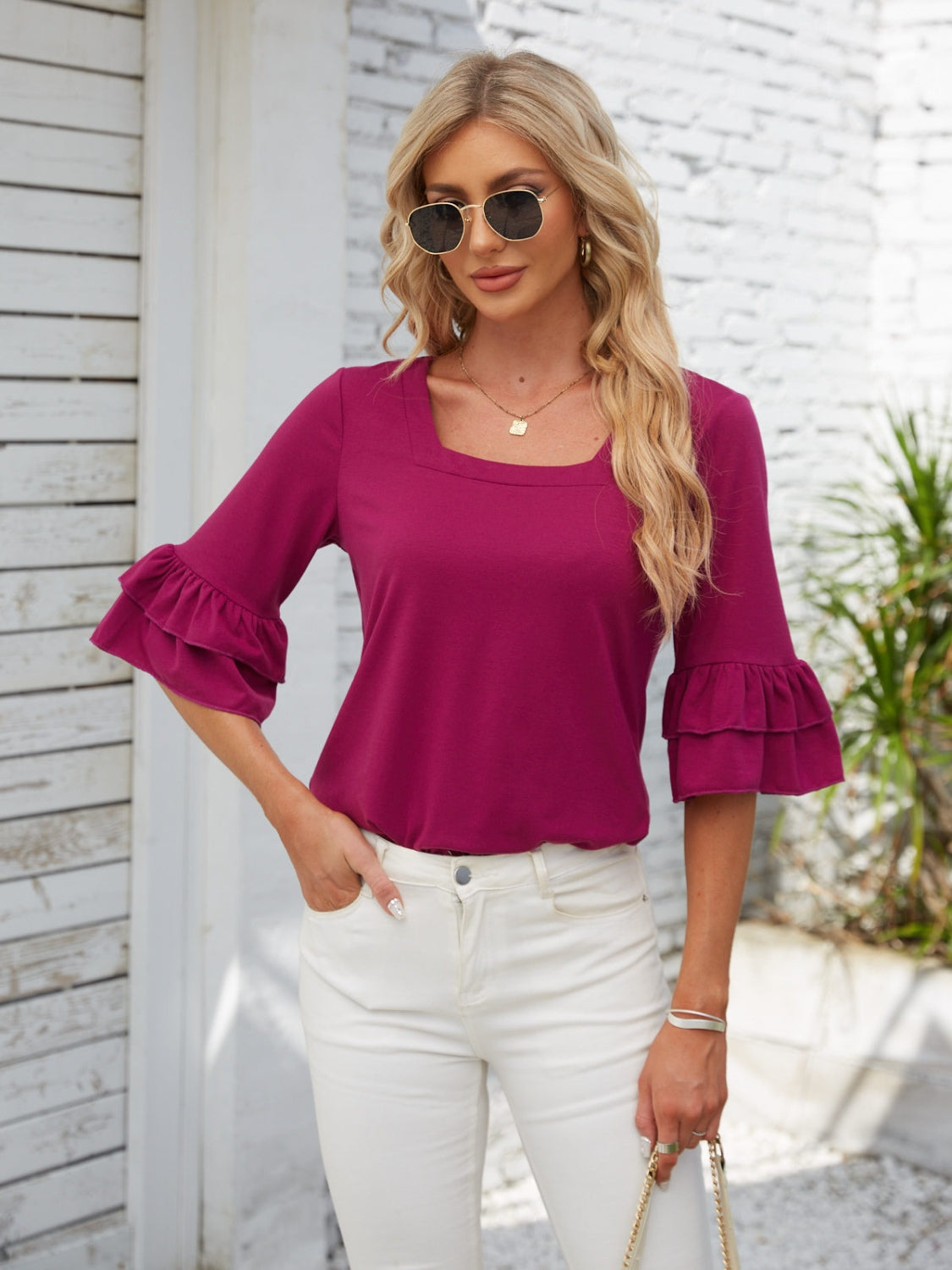 Ruffled sleeve square neck top in magenta pink with tiered ruffle sleeves.