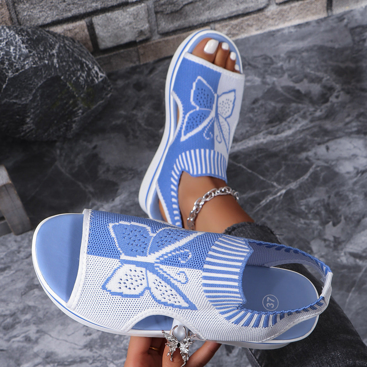 Blue and white mesh butterfly wedge sandals with open toe and chunky heel.