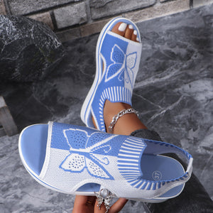 Blue and white mesh butterfly wedge sandals with open toe and chunky heel.
