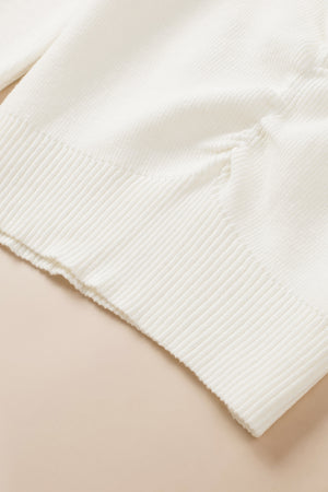 Ivory ribbed knit sweater with ruched front detail and ribbed trim