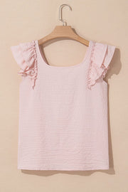 Blush pink textured blouse with square neck and ruffle cap sleeves.