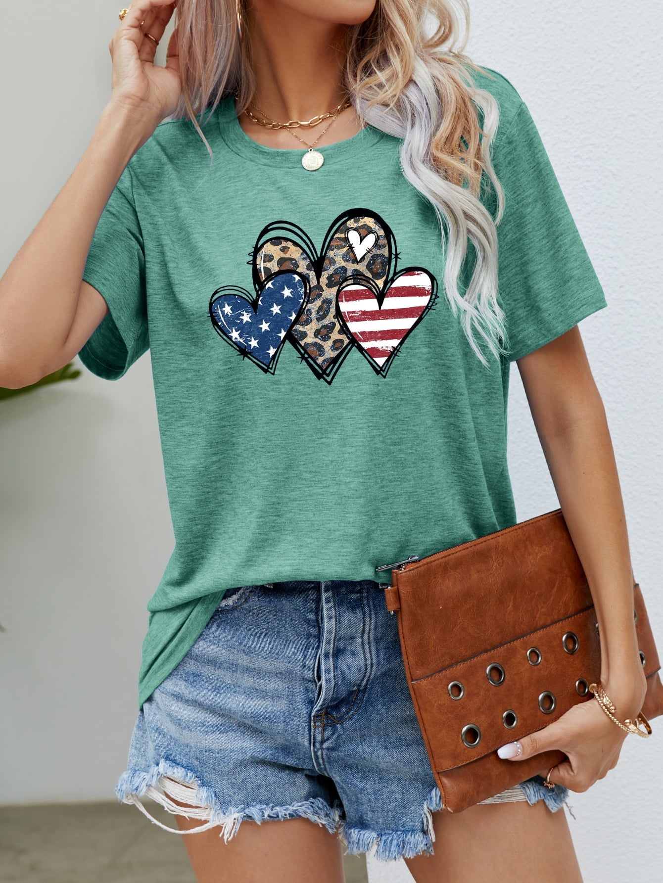 Green crew neck t-shirt with leopard print and American flag hearts graphic.