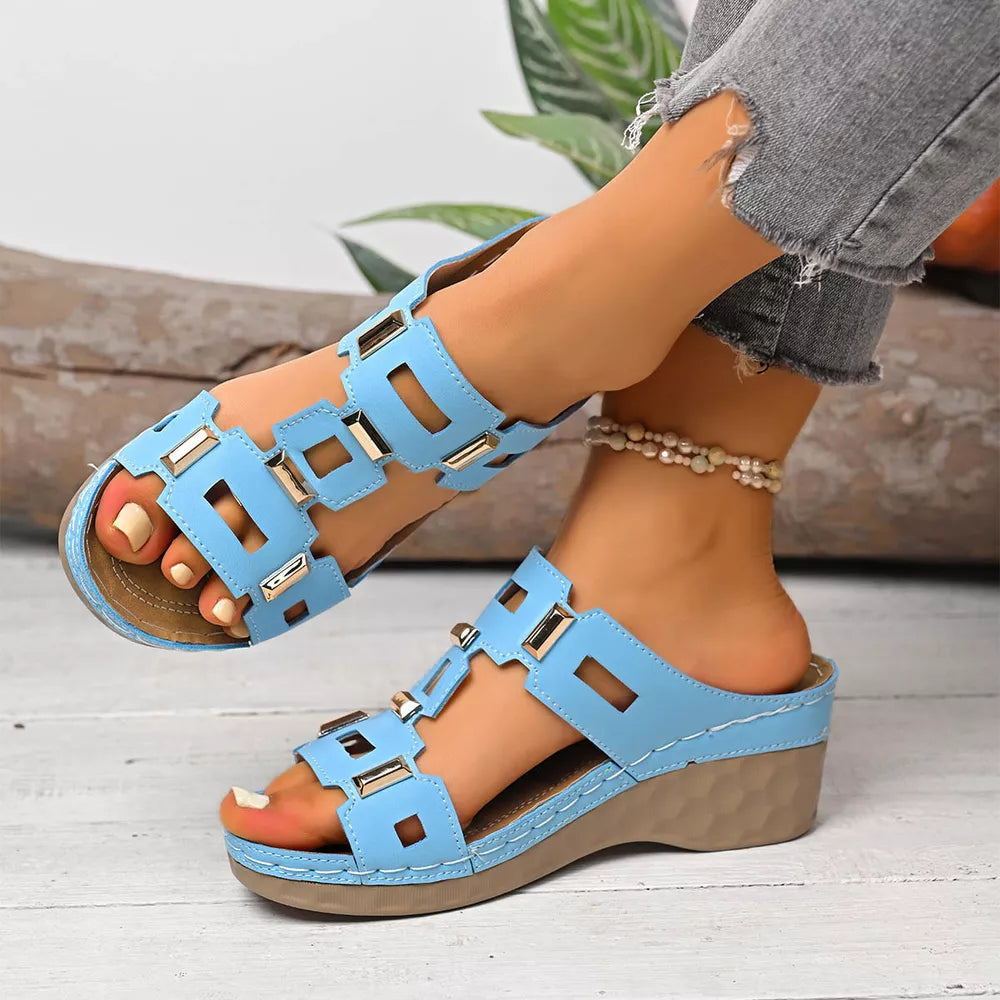 Sky blue open-toe wedge sandals with gold accents and cut-out details.