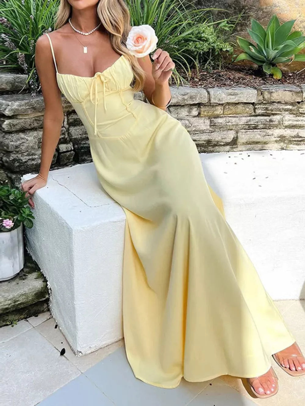 Pastel yellow tie-front maxi dress with spaghetti straps and a cinched waist.
