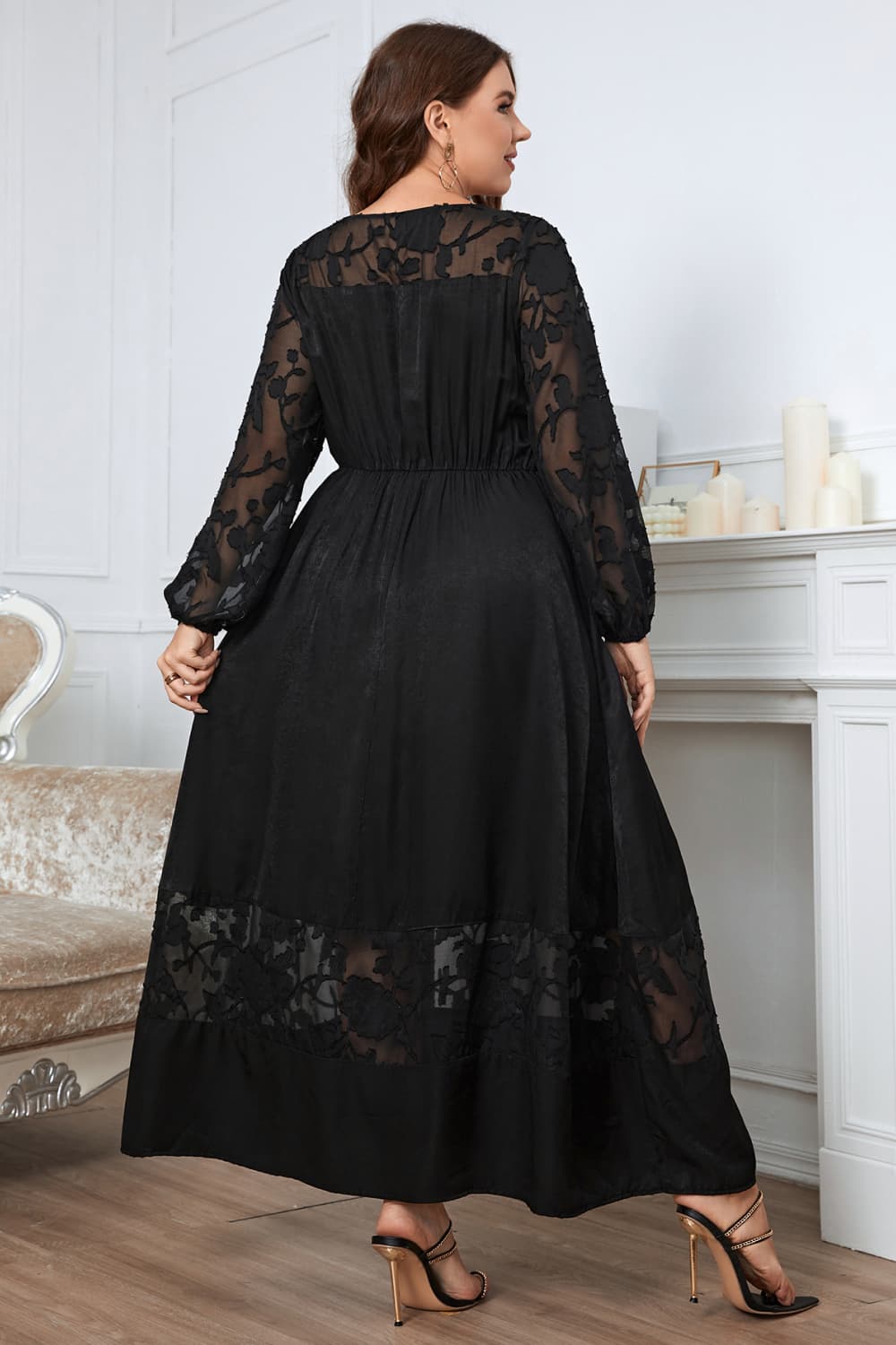 Black maxi dress with sheer embroidered sleeves and hem, A-line cut.
