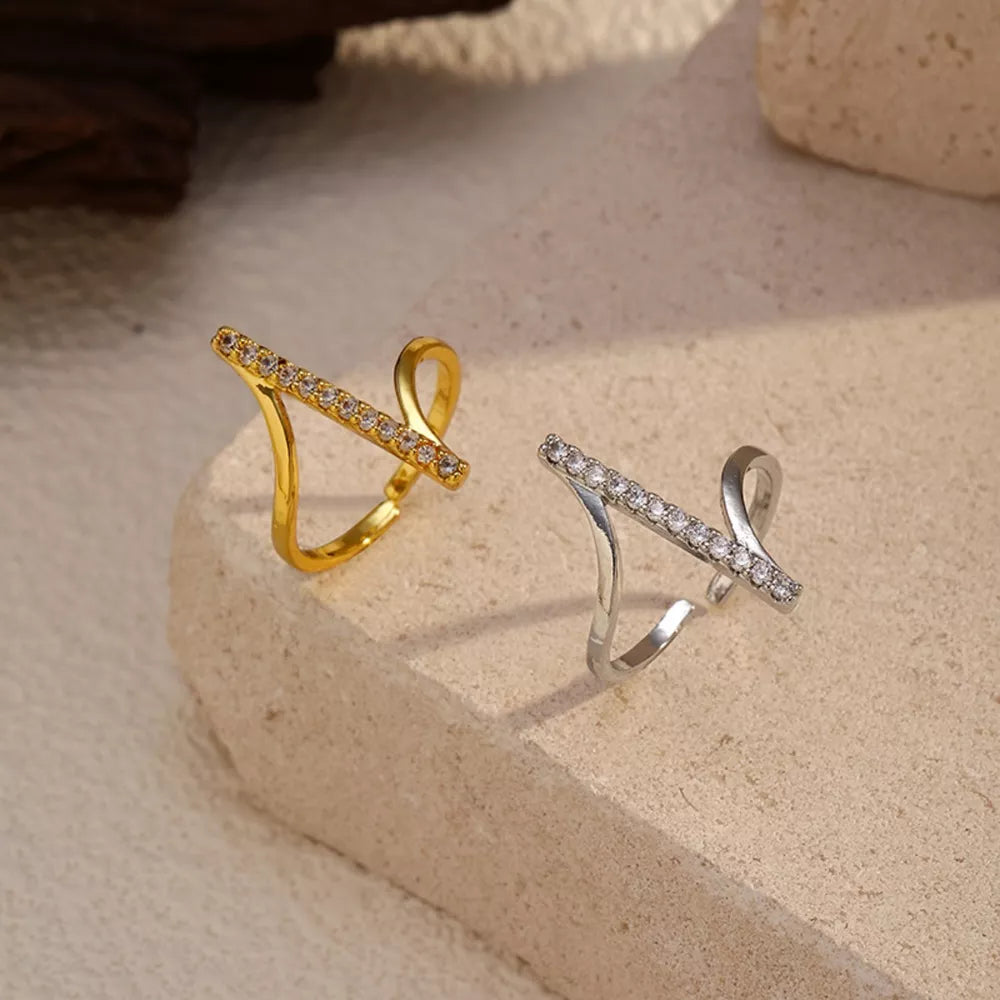 Contemporary gold and gray rings with rhinestone embellishments.