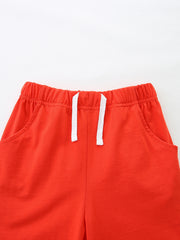 Red cotton toddler shorts with elastic waistband and white drawstring.