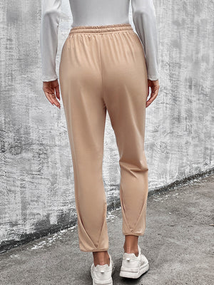 Beige utility joggers with tapered hemline and elastic waistband.