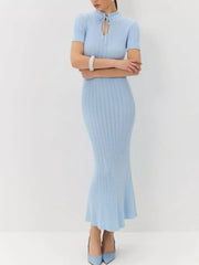 Light blue knit mermaid dress with short sleeves and tied neckline.