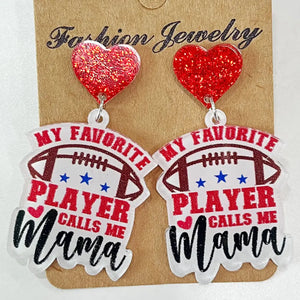 Acrylic football earrings with red glitter hearts, "My Favorite Player Calls Me Mama" text.