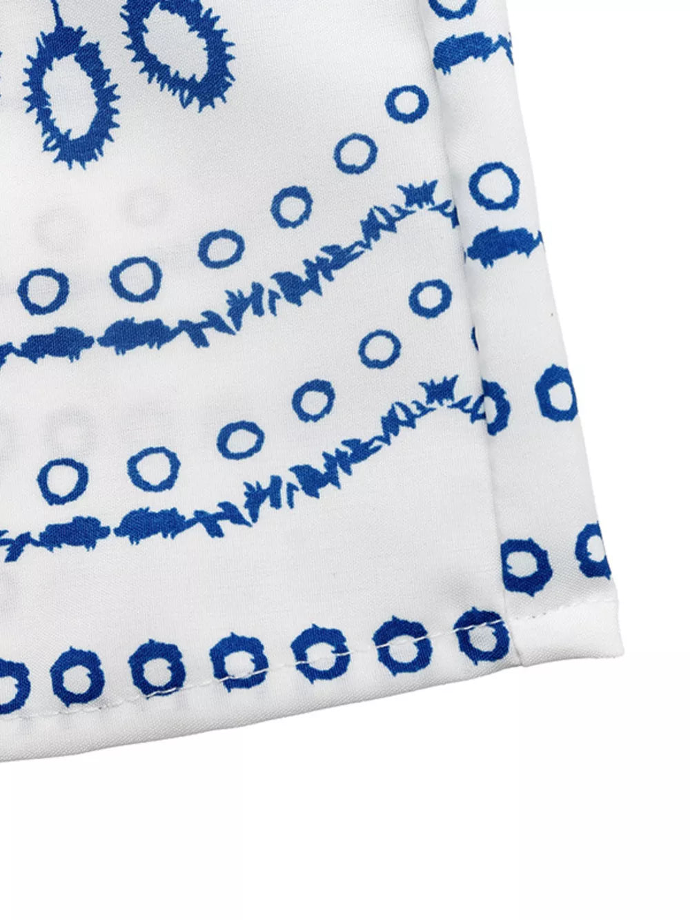 Bohemian maxi skirt with blue floral embroidery on white fabric.