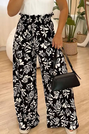 Black botanical ruffle waist palazzo trousers with a wide leg.