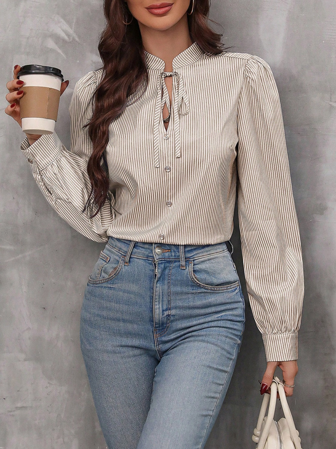 Puffed sleeve stripe blouse with keyhole neckline and tie detail.
