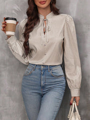 Puffed sleeve stripe blouse with keyhole neckline and tie detail.