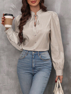 Puffed sleeve stripe blouse with keyhole neckline and tie detail.