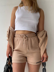 Textured gauze shirt and short co-ord set in blush pink, casual button-up style.
