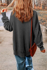 Oversized charcoal washed cotton sweatshirt with crew neck and cuffed sleeves.