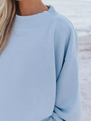 Sky blue crew neck sweatshirt with ribbed neckline and cuffs, part of a lounge set.