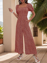 Rust floral print wide leg jumpsuit with smocked bodice and square neck.