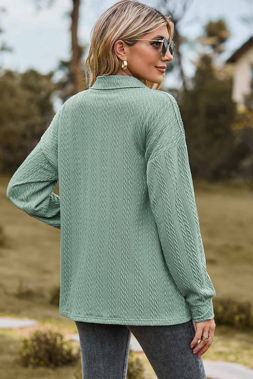 Light green textured polo-neck sweater with button detail and long sleeves.