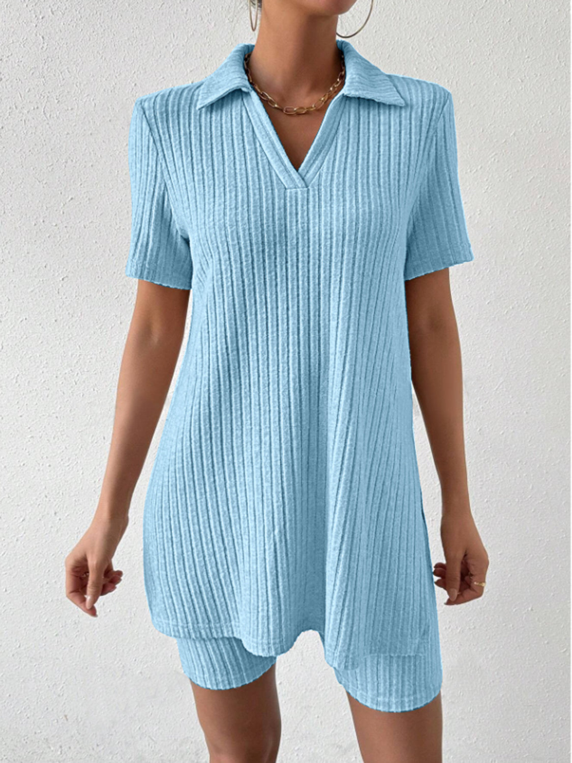 Light blue ribbed polo shirt and shorts co-ord set with a v-neck and collar.