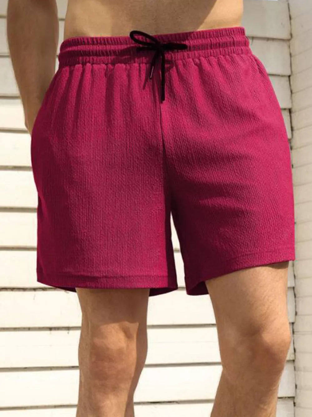 Men's burgundy chino shorts with drawstring waist and textured fabric.