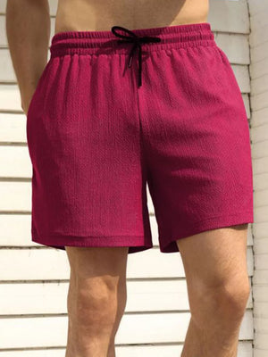 Men's burgundy chino shorts with drawstring waist and textured fabric.