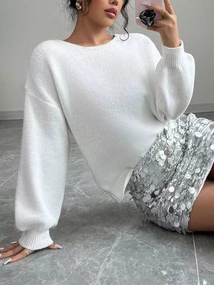 Chic white knit cardigan with balloon sleeves and ribbed cuffs.