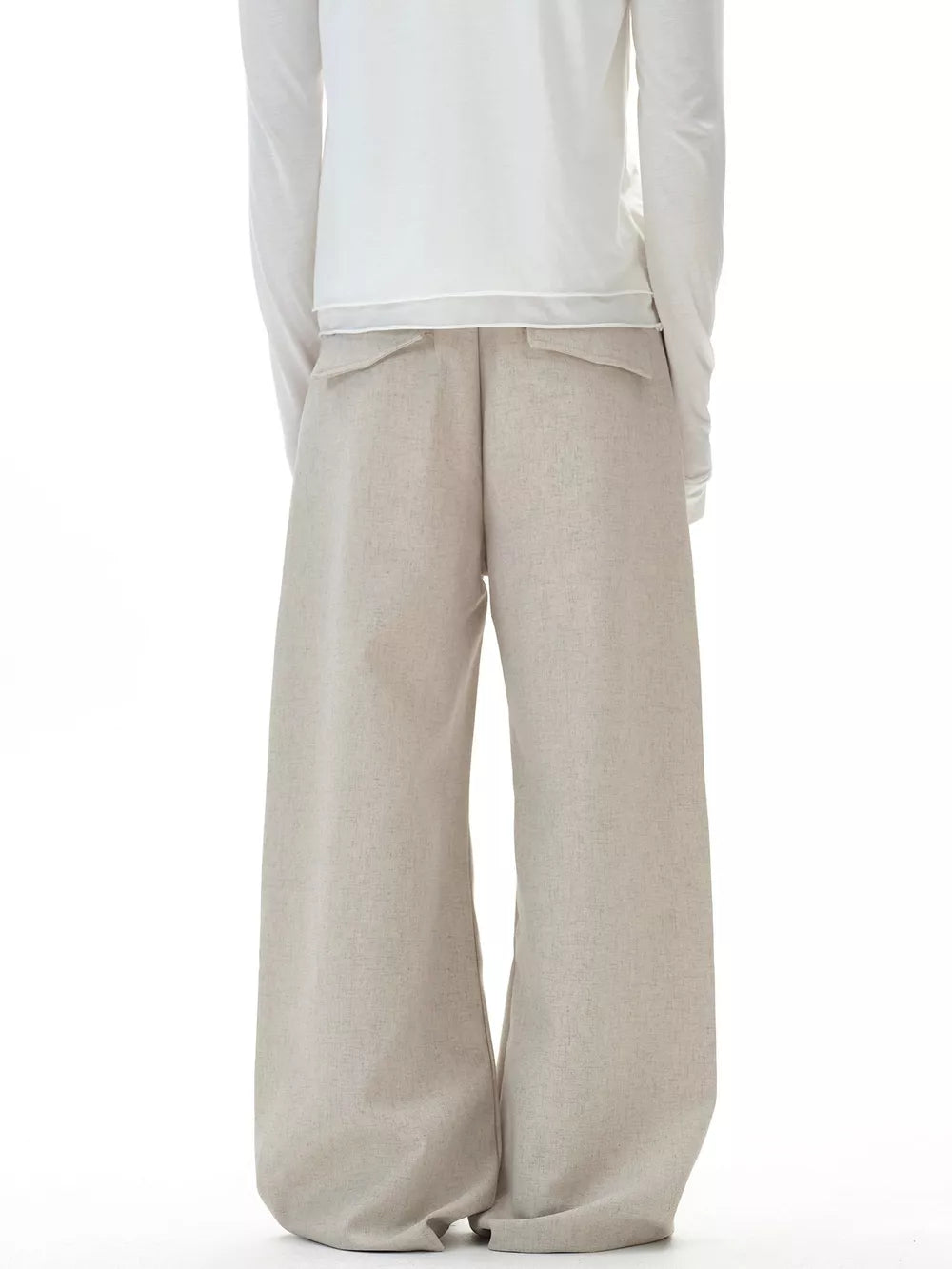 Men's beige wide-leg cargo pants with button closure and flap pockets.