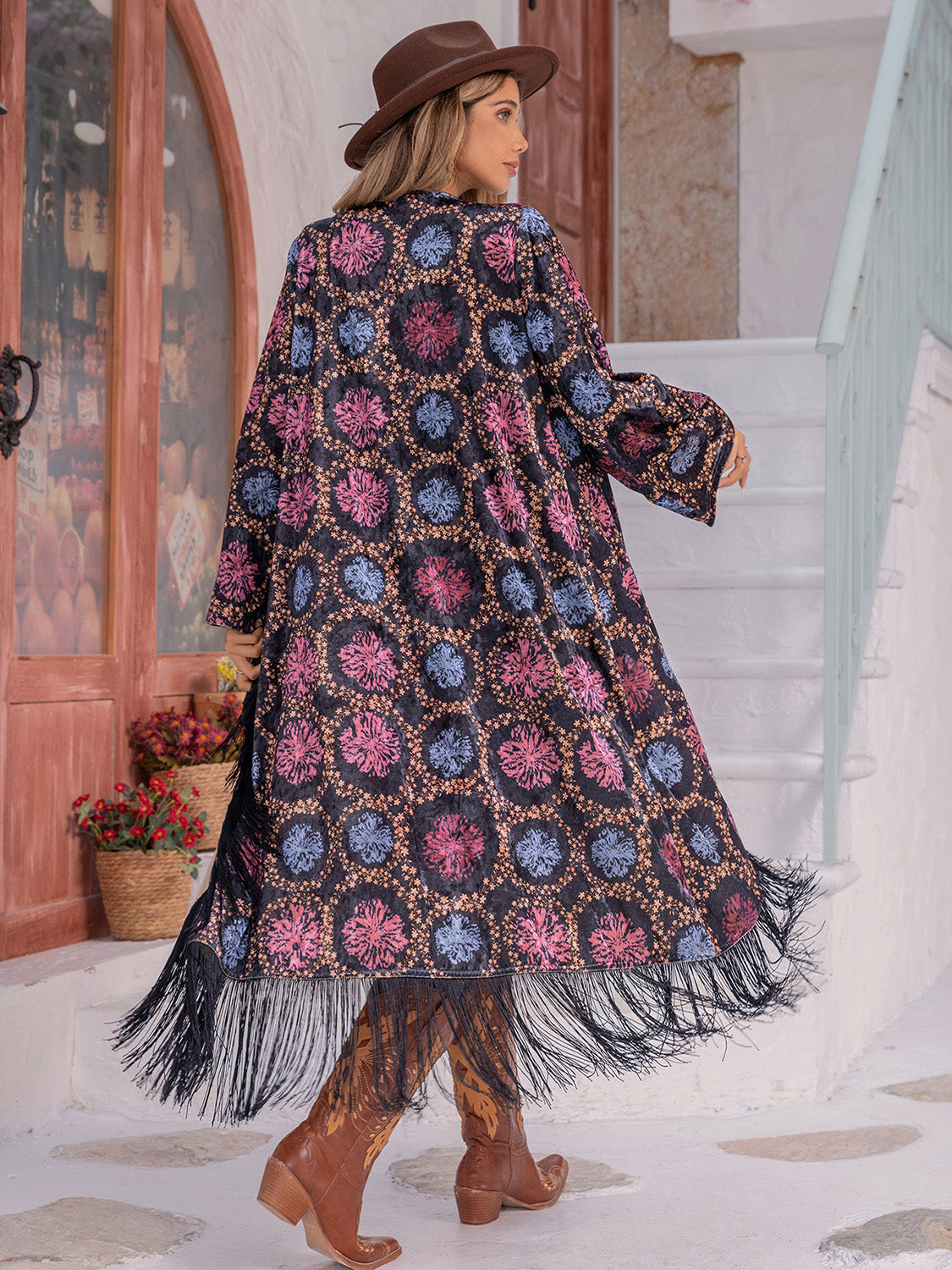 Bohemian duster with multicolor floral print and fringe hem, open front, long sleeves.