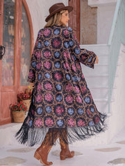 Bohemian duster with multicolor floral print and fringe hem, open front, long sleeves.