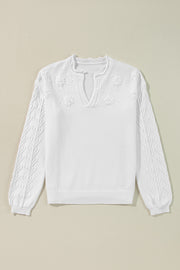 White embroidered floral knit sweater with notch neck and textured sleeves.