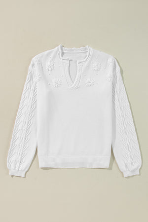 White embroidered floral knit sweater with notch neck and textured sleeves.