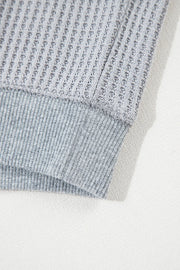 Gray waffle knit top with ribbed hem detail