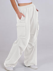 White cargo pocket drape wide leg pants with drawstring detail.