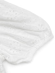 White eyelet puff sleeve bodysuit with floral embroidery detail.