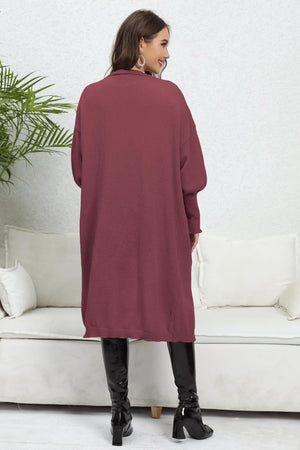 Burgundy oversized pocketed knit cardigan with long sleeves and a relaxed fit.