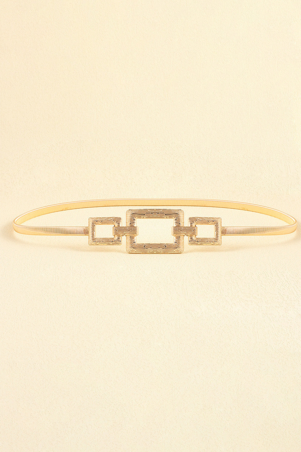 Gold elasticated belt with geometric rectangle buckle detail