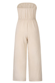 Tan bandeau tie-waist wide-leg jumpsuit with smocked bodice and cropped length.